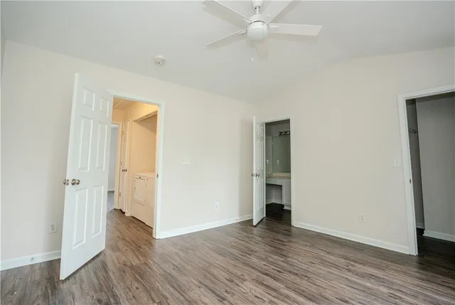 an empty room with wooden floor and closet