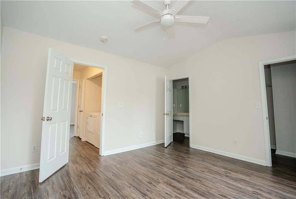 4645 Valais Court, Unit 109 Alpharetta, GA 30022 - Photo 17 of 27 an empty room with wooden floor and closet