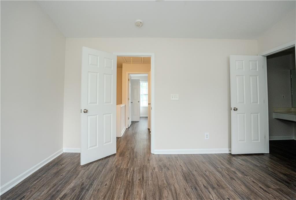 4645 Valais Court, Unit 109 Alpharetta, GA 30022 - Photo 22 of 27 a view of an empty room with wooden floor and closet
