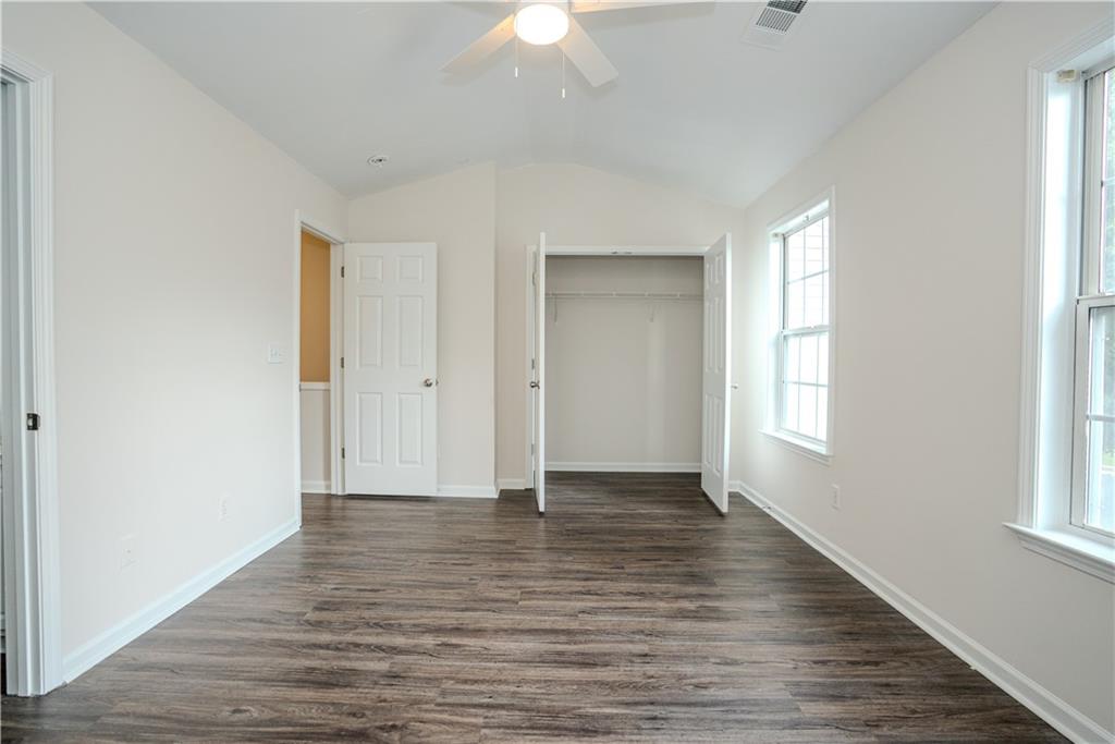 4645 Valais Court, Unit 109 Alpharetta, GA 30022 - Photo 24 of 27 wooden floor in an empty room with a window