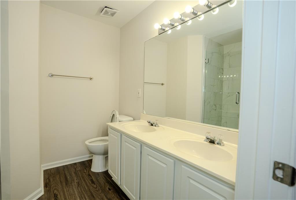 4645 Valais Court, Unit 109 Alpharetta, GA 30022 - Photo 25 of 27 a bathroom with a sink and a mirror