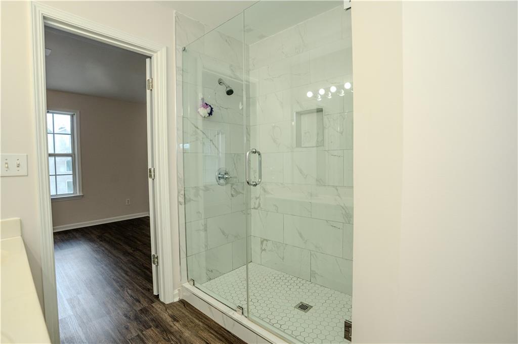 4645 Valais Court, Unit 109 Alpharetta, GA 30022 - Photo 26 of 27 a bathroom with a shower