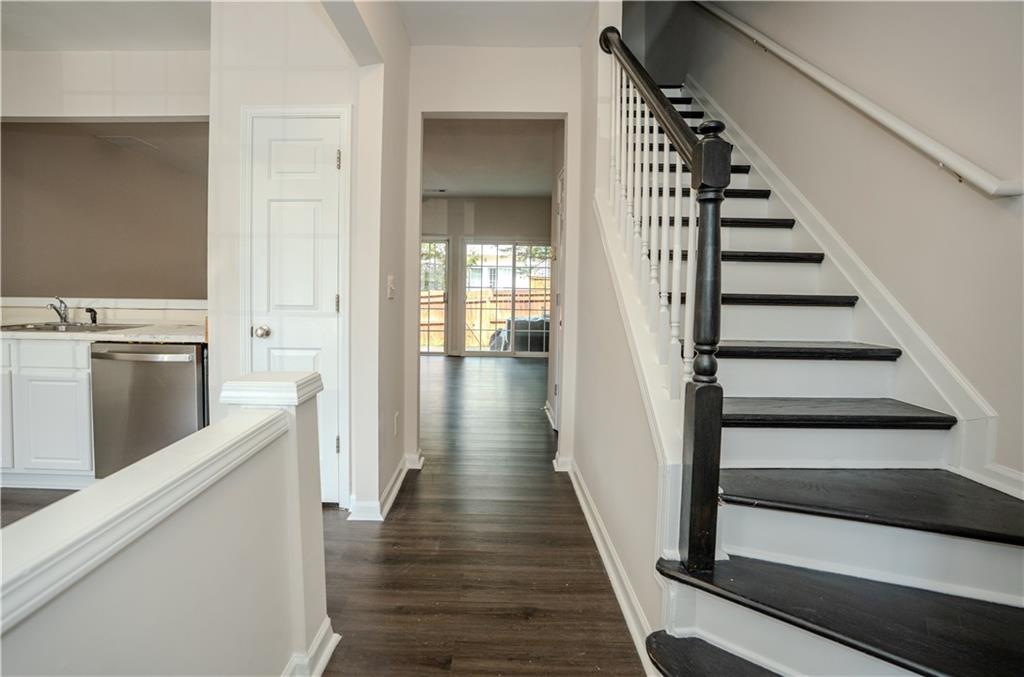 4645 Valais Court, Unit 109 Alpharetta, GA 30022 - Photo 9 of 27 a view of a hallway with wooden floor and entryway