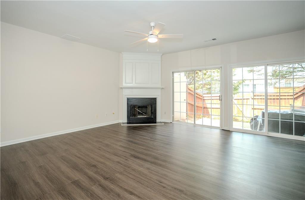 4645 Valais Court, Unit 109 Alpharetta, GA 30022 - Photo 10 of 27 a view of an empty room with wooden floor and a window