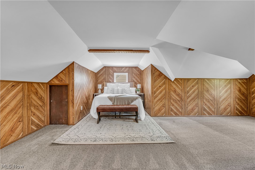 1828 South Green Road Cleveland, OH 44121 - Photo 23 of 30 Carpeted bedroom with vaulted ceiling with beams and wooden walls