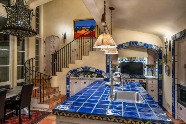 a bathroom with a granite countertop sink and a shower