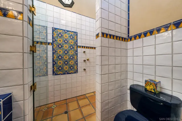 a bedroom with a bed and a flat tv screen on dresser