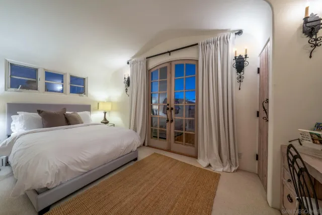 a view of a patio with table and chairs under an umbrella