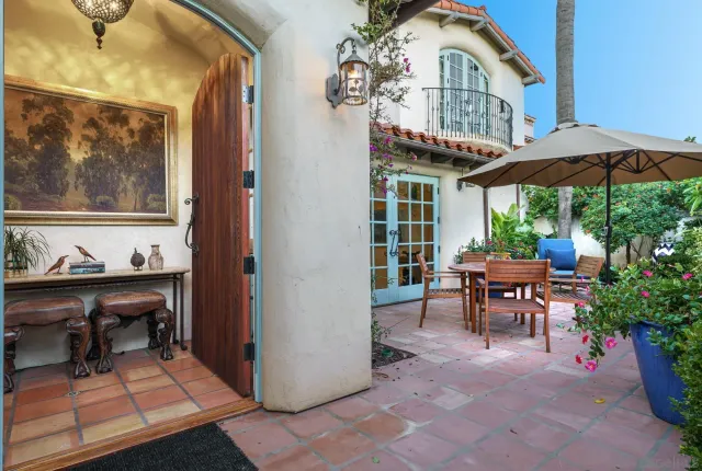 a view of a house with backyard and sitting area