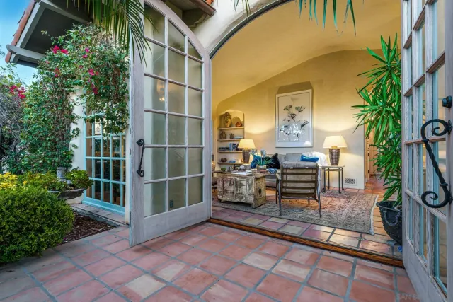 a view of a porch with chairs and potted plants