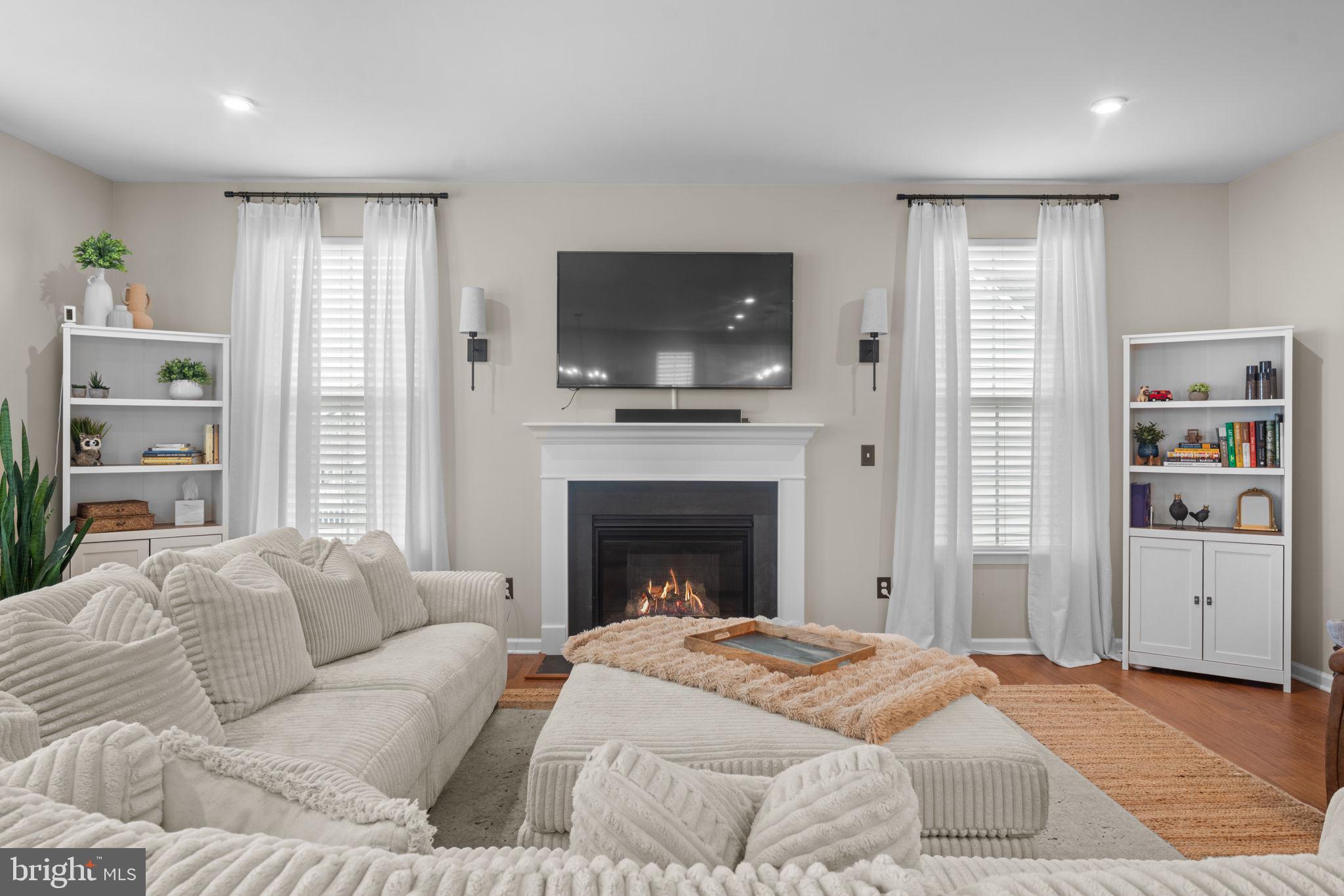 12432 Mays Quarter Road Woodbridge, VA 22192 - Photo 17 of 94 a living room with furniture and a fireplace