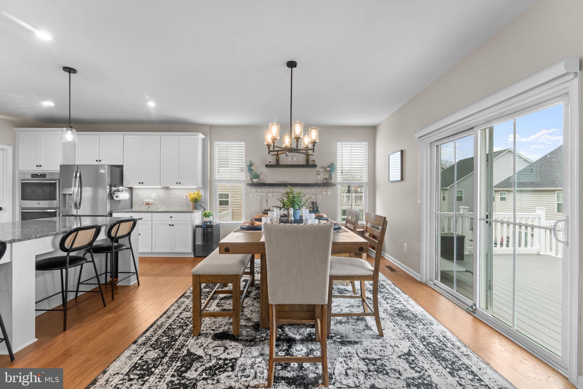 12432 Mays Quarter Road Woodbridge, VA 22192 - Photo 27 of 94 a dining room with furniture a chandelier and wooden floor