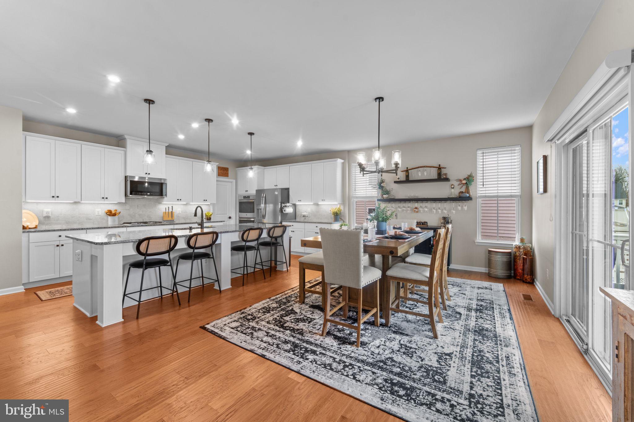 12432 Mays Quarter Road Woodbridge, VA 22192 - Photo 28 of 94 a view of a dining room with furniture window and wooden floor