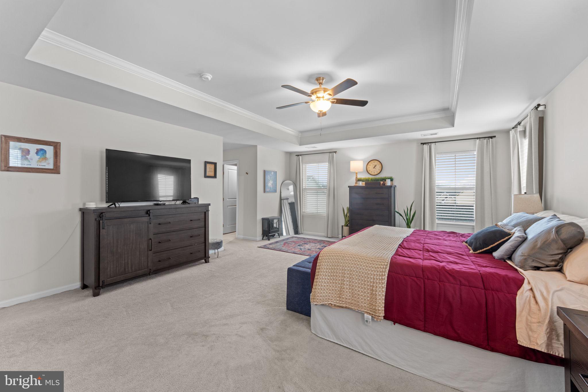 12432 Mays Quarter Road Woodbridge, VA 22192 - Photo 35 of 94 a spacious bedroom with a bed and a flat screen tv