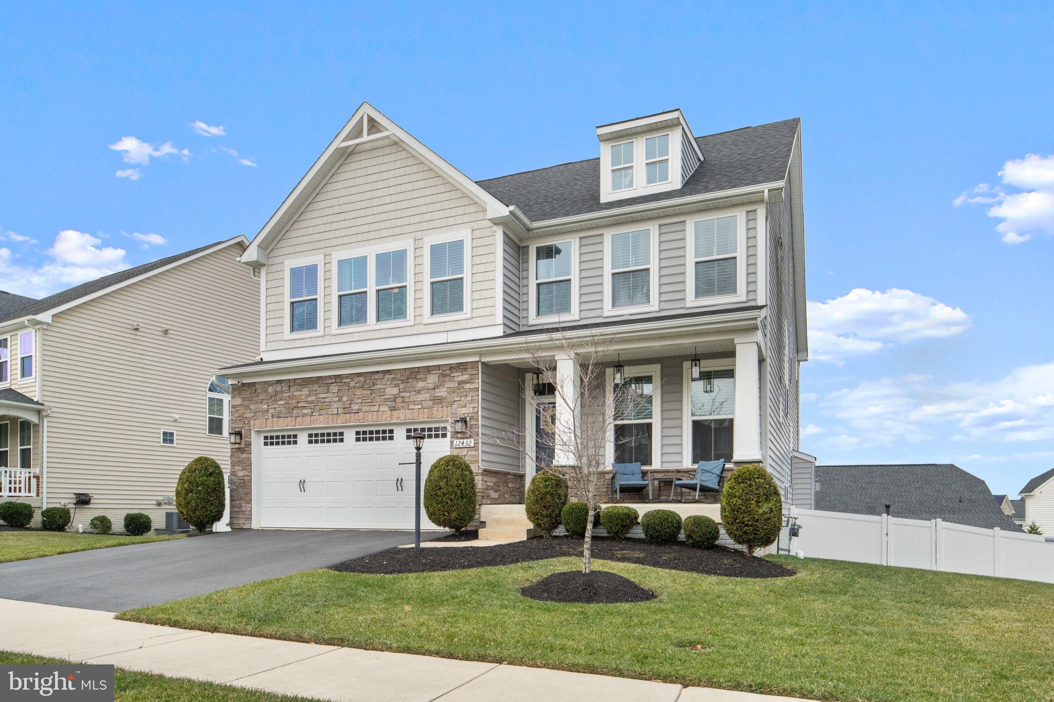 12432 Mays Quarter Road Woodbridge, VA 22192 - Photo 4 of 94 a front view of a house with a yard and potted plants