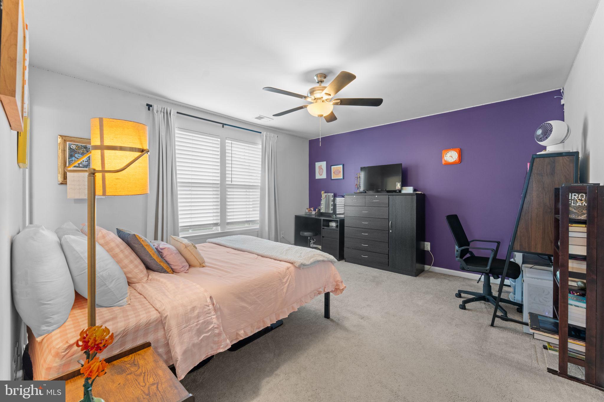12432 Mays Quarter Road Woodbridge, VA 22192 - Photo 48 of 94 a bedroom with a bed dresser and a chandelier