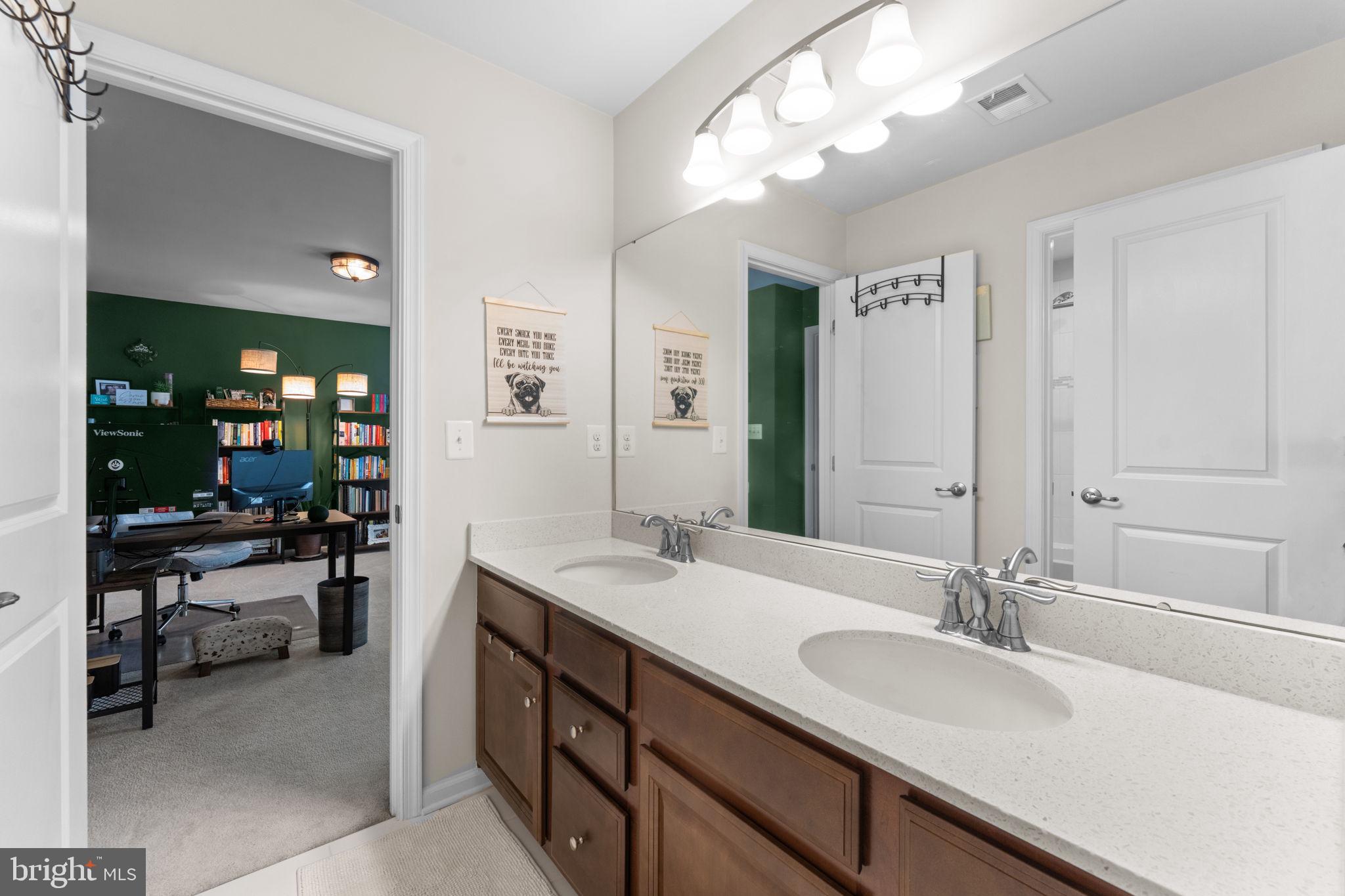 12432 Mays Quarter Road Woodbridge, VA 22192 - Photo 51 of 94 a bathroom with a sink double vanity and a mirror