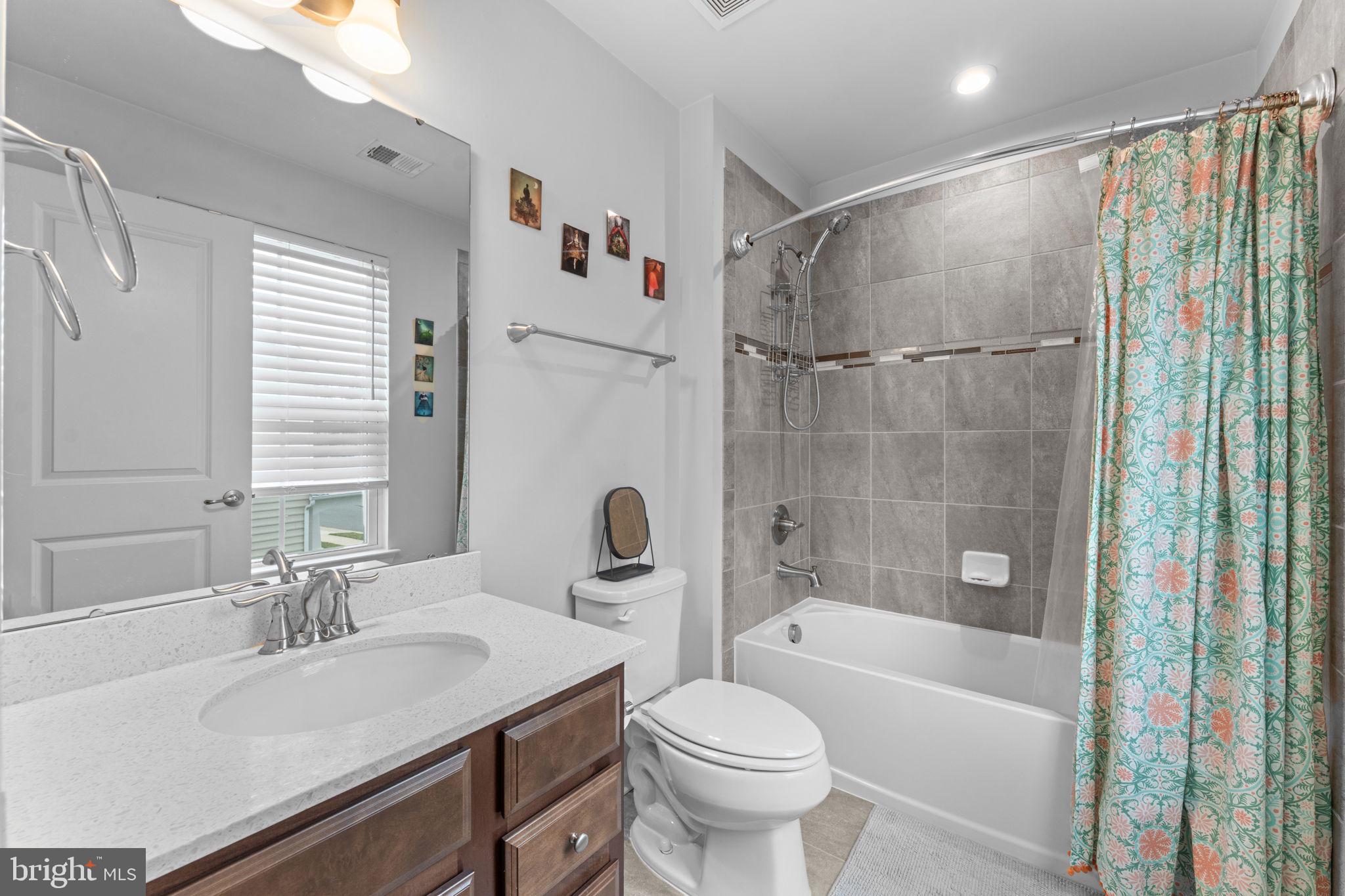 12432 Mays Quarter Road Woodbridge, VA 22192 - Photo 53 of 94 a bathroom with a sink toilet and shower