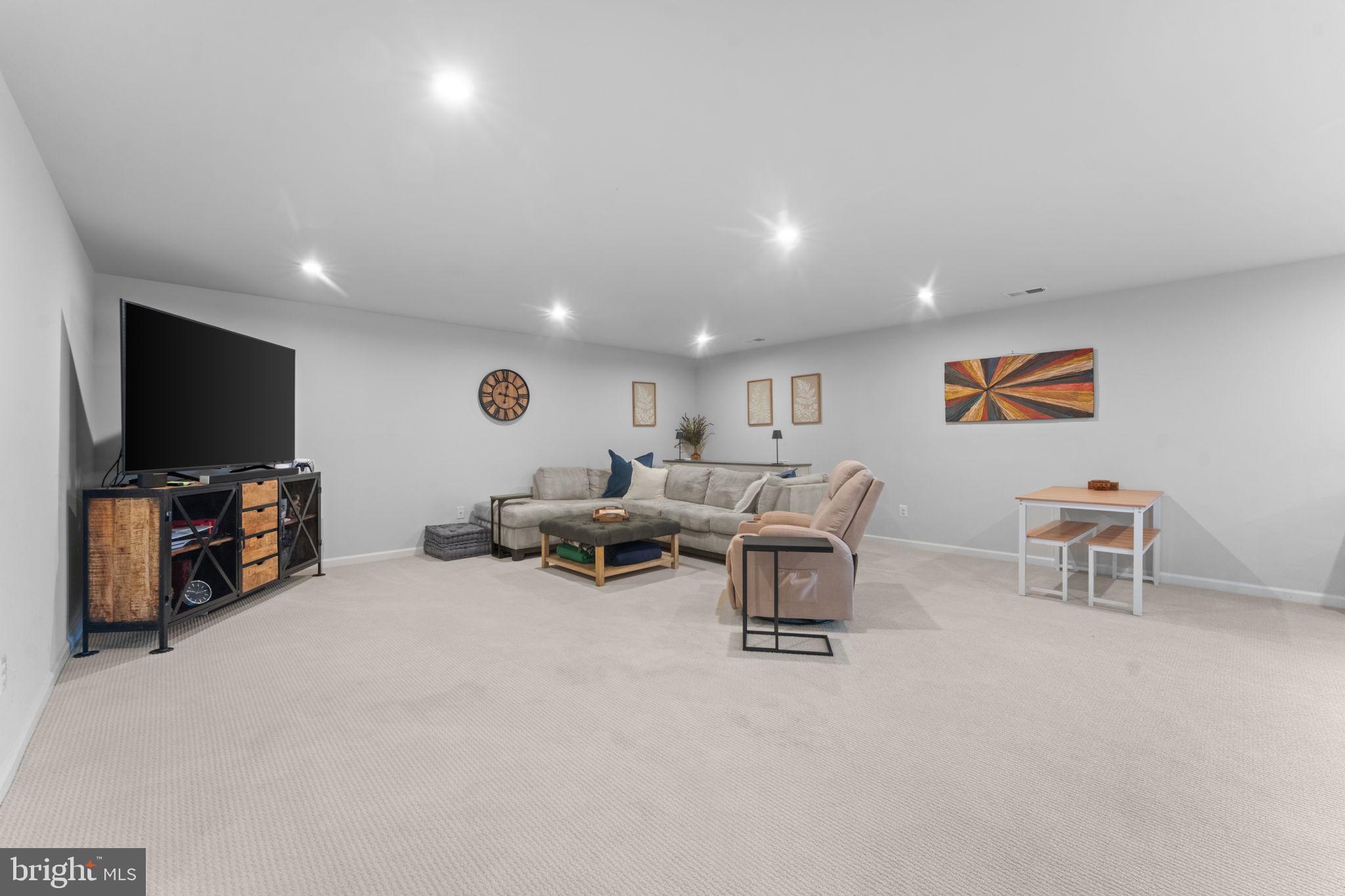 12432 Mays Quarter Road Woodbridge, VA 22192 - Photo 66 of 94 a living room with furniture and a flat screen tv