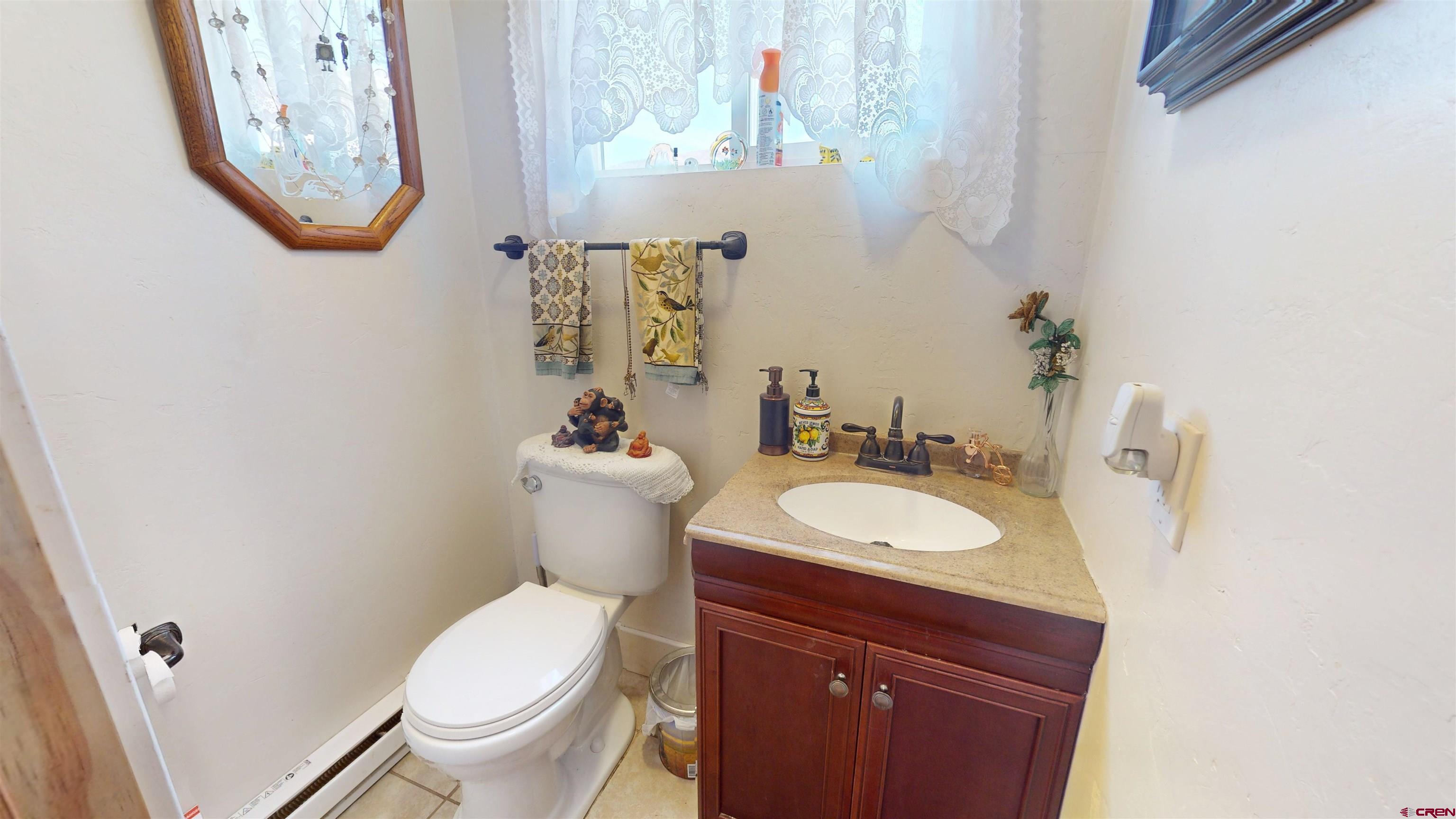 19253 Stevens Gulch Road Paonia, CO 81428 - Photo 30 of 43 a bathroom with a toilet sink and mirror