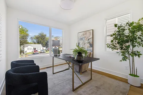 a bathroom with a granite countertop bathtub sink vanity mirror and toilet