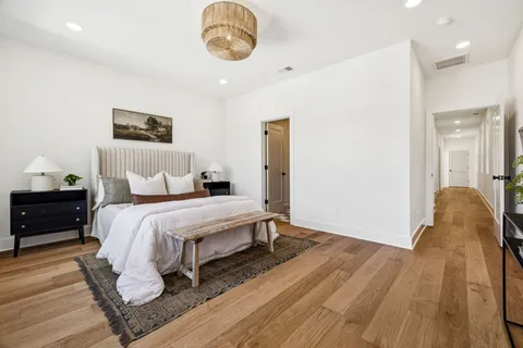 a bedroom with a bed and a painting on the wall