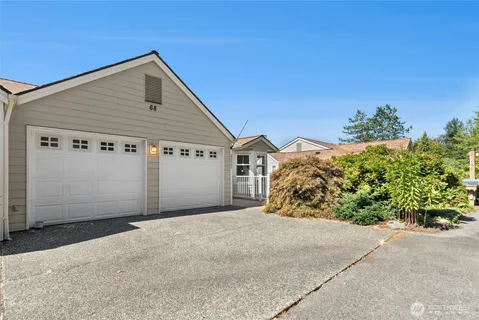 a view of a house with a yard and plant in front of it