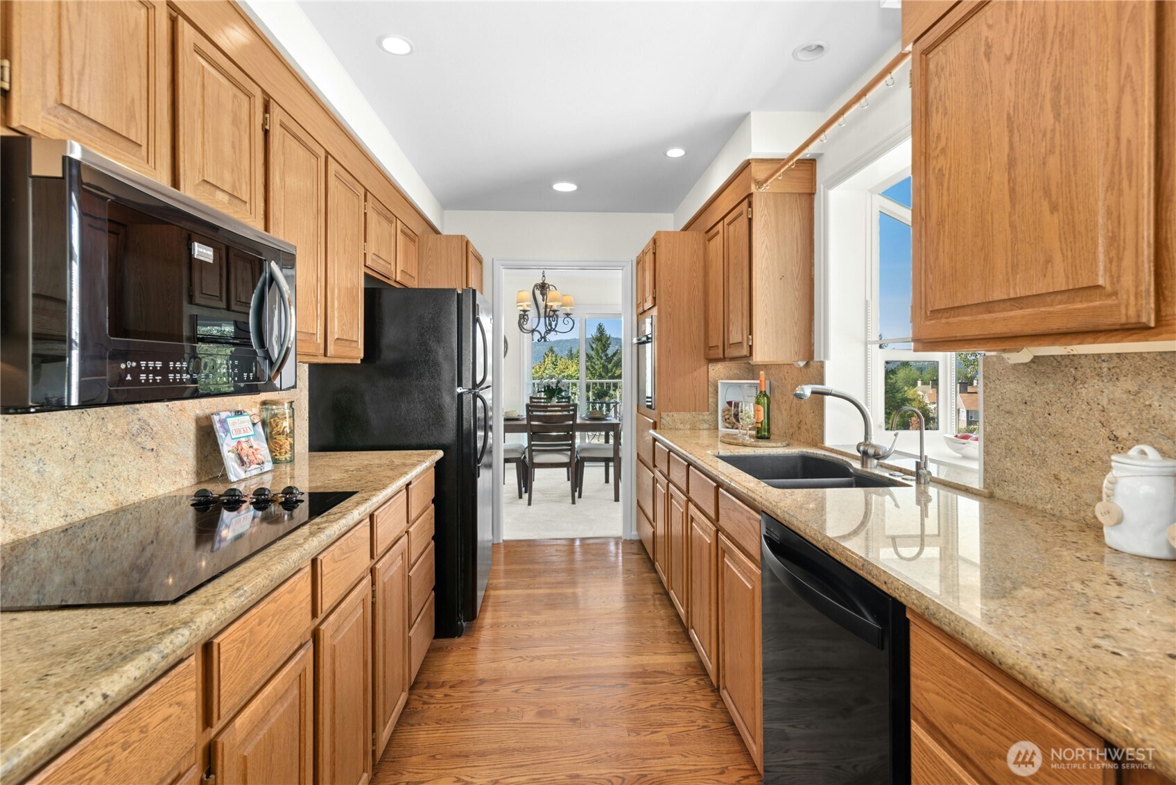 22541 Southeast 42nd Court, Unit 2252 Issaquah, WA 98029 - Photo 13 of 37 a kitchen with stainless steel appliances granite countertop a sink a stove and a refrigerator