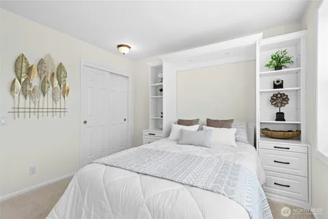 a bedroom with a bed and a window