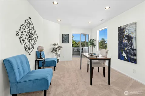 a living room with furniture and a potted plant