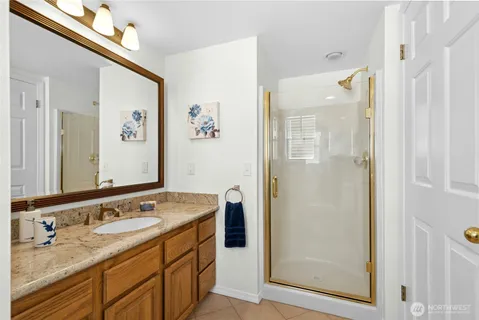 a bathroom with a granite countertop sink mirror and double