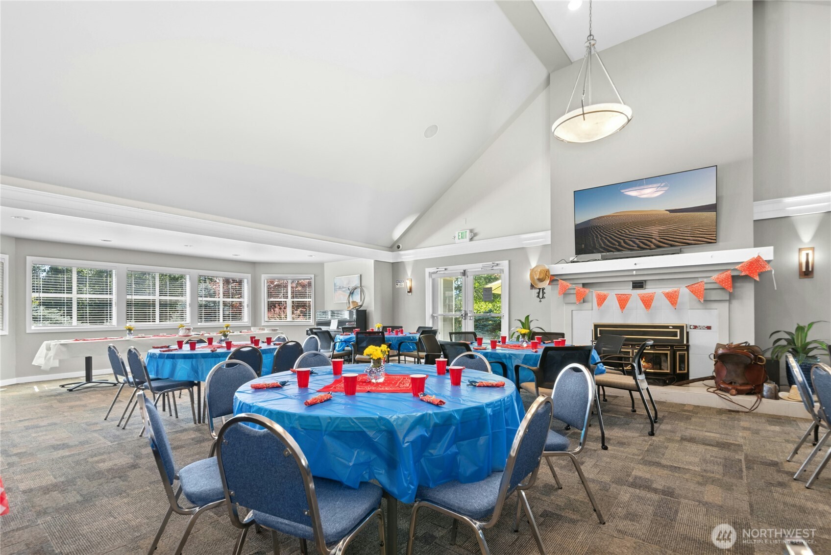 22541 Southeast 42nd Court, Unit 2252 Issaquah, WA 98029 - Photo 33 of 37 a view of a dining room with furniture a fireplace and a flat screen tv