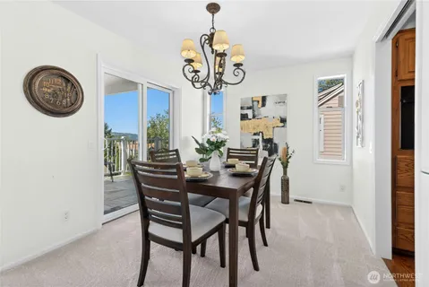 a view of a dining room with furniture and a window