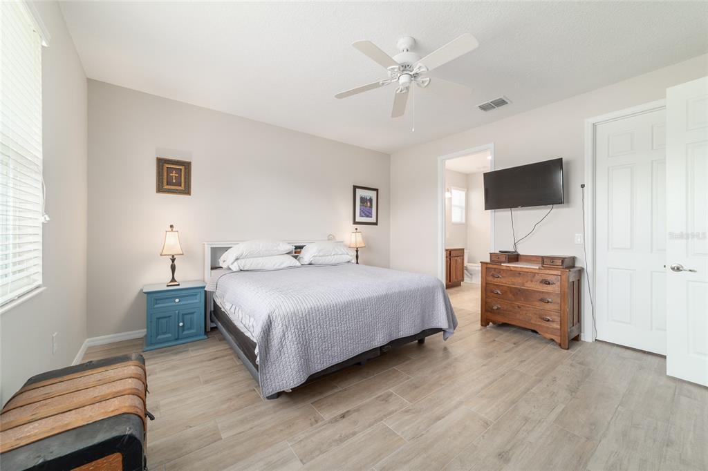 9236 Southwest 91st Ct Road Ocala, FL 34481 - Photo 27 of 48 a bedroom with a bed and a flat screen tv