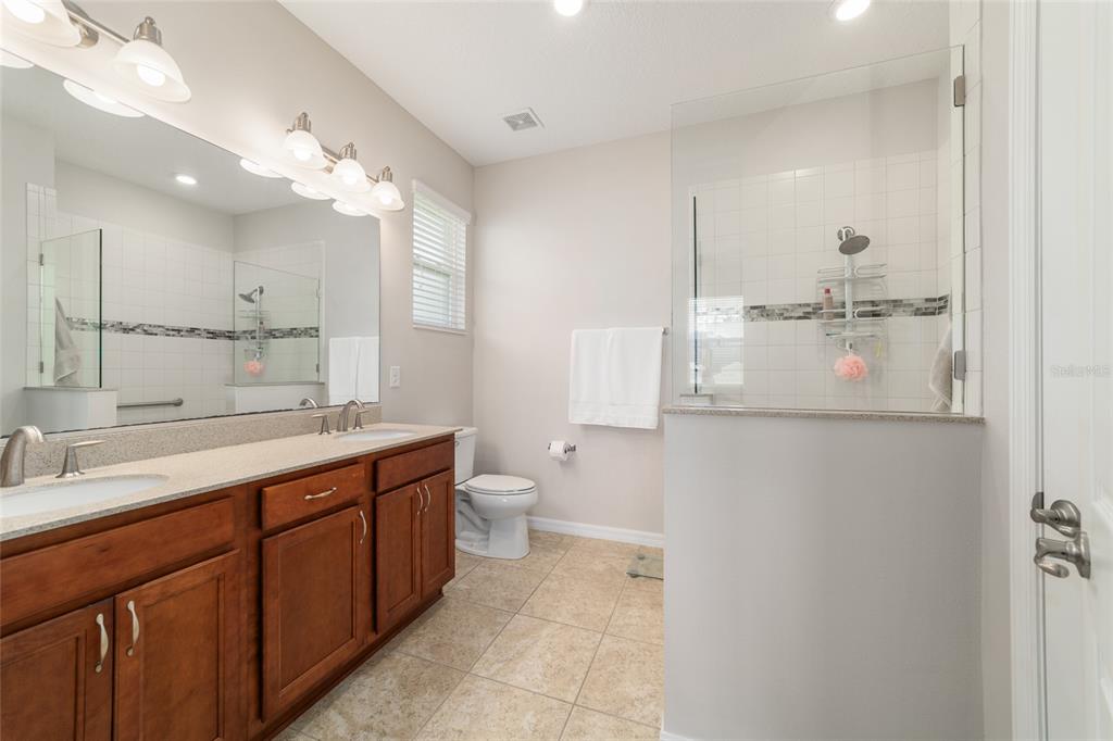 9236 Southwest 91st Ct Road Ocala, FL 34481 - Photo 29 of 48 a bathroom with a double vanity sink mirror and toilet