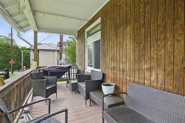 a view of a chairs and table in the balcony