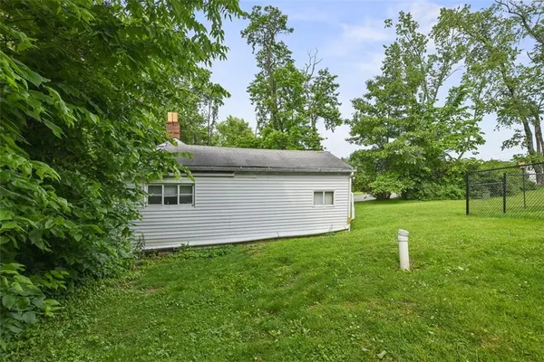a view of a house with a backyard and a garden