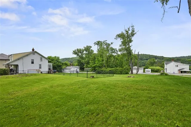 a view of a garden with a house in the background