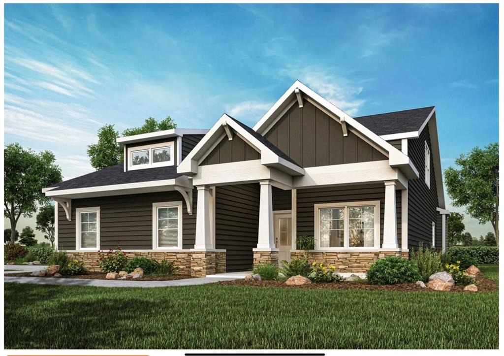 a front view of a house with a yard and plants