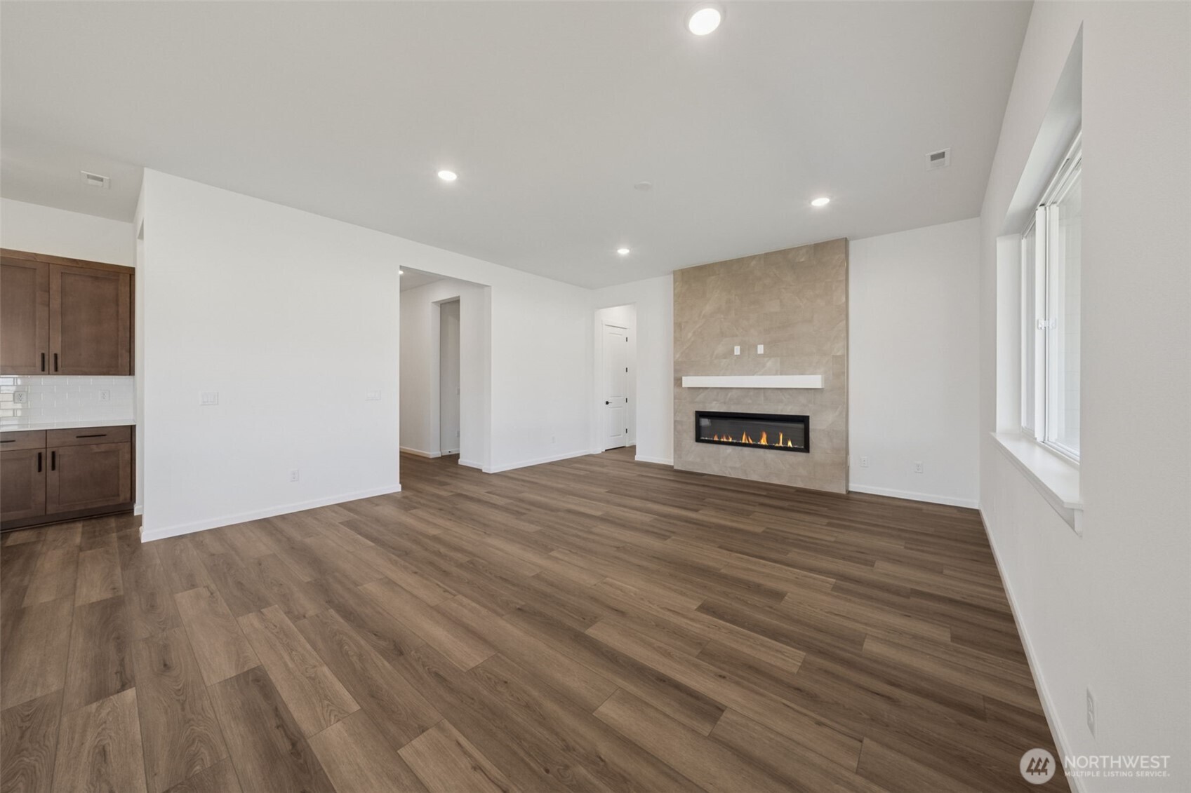 932 Lucas Avenue, Unit 21 Buckley, WA 98321 - Photo 12 of 30 a view of empty room with a fireplace and wooden floor