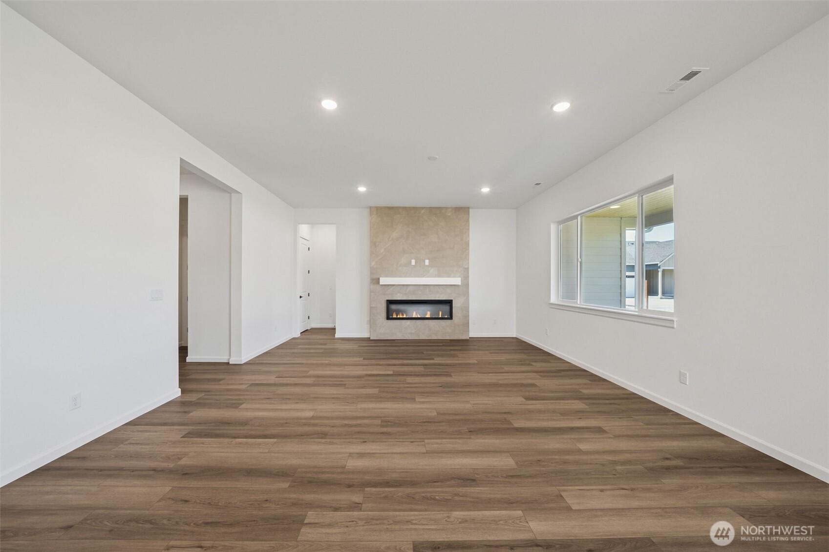 932 Lucas Avenue, Unit 21 Buckley, WA 98321 - Photo 13 of 30 a view of an empty room with a window and fireplace