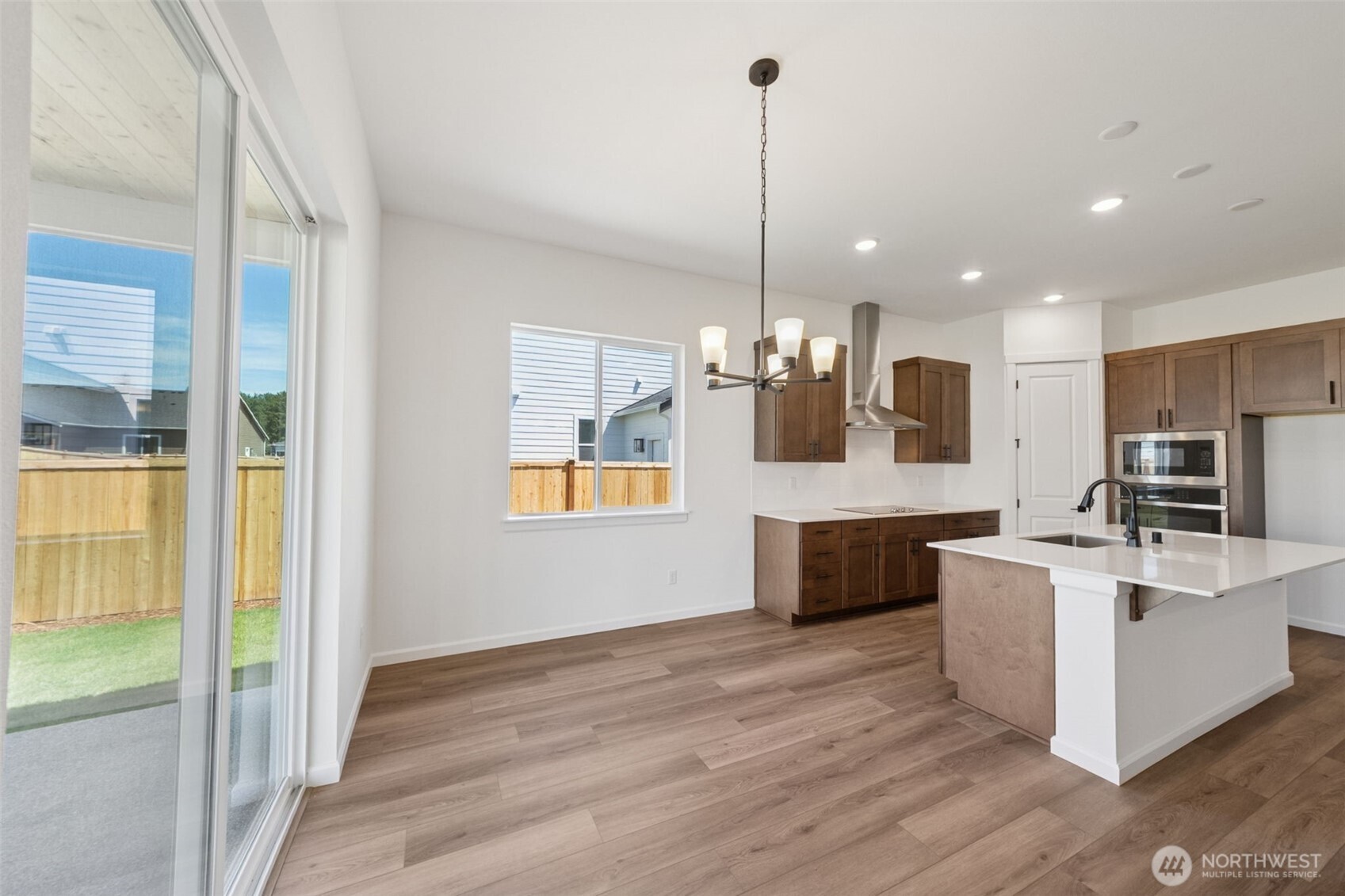 932 Lucas Avenue, Unit 21 Buckley, WA 98321 - Photo 23 of 30 a large kitchen with kitchen island a large counter top a sink appliances and cabinets