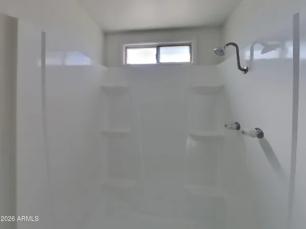 a bathroom with a sink a large mirror and a shower