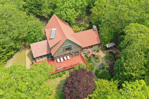 an aerial view of a house with yard and street view