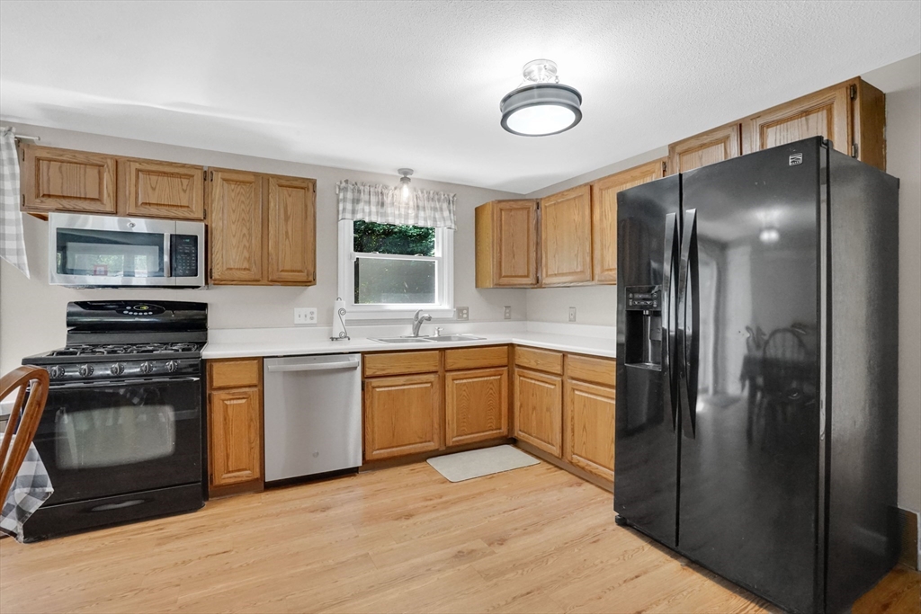 19 Ruthven Street Springfield, MA 01128 - Photo 7 of 19 a kitchen with stainless steel appliances granite countertop a refrigerator stove and sink