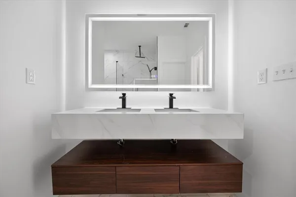 a bathroom with a sink and a mirror