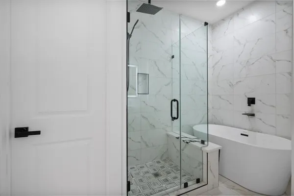 a bathroom with a bathtub and shower