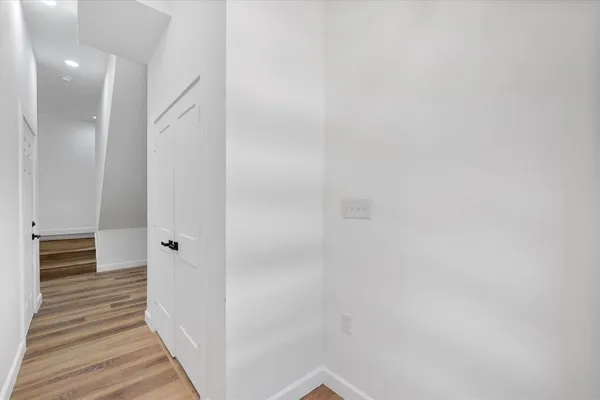 a view of a hallway with wooden floor
