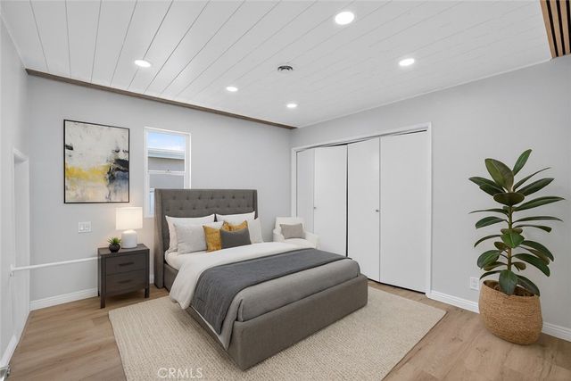 a bedroom with a bed and a potted plant