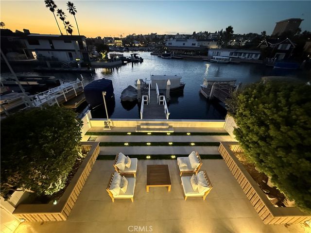 a view of a swimming pool with outdoor seating and lake view